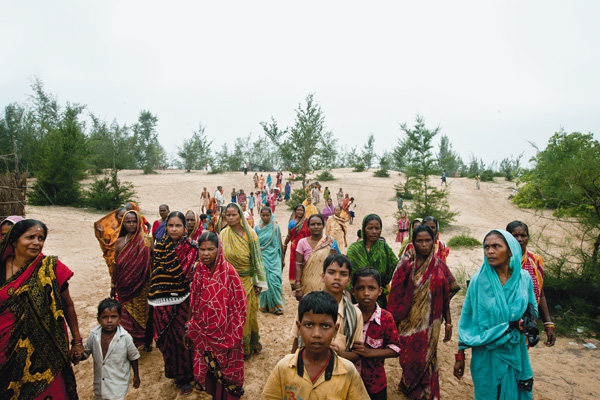 A LONG WALK HOME Women and children from Dhinkia return from a rally to prevent the police from taking down betel vines, their main source of livelihood. Most of the betel vines grow on the 2,900 acres of forest land that the Posco project will take over