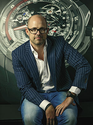 Water works: HYT co-founder Vincent Perriard (with an H2 watch in the background) is expanding the business to include lower-priced timepieces with increased production