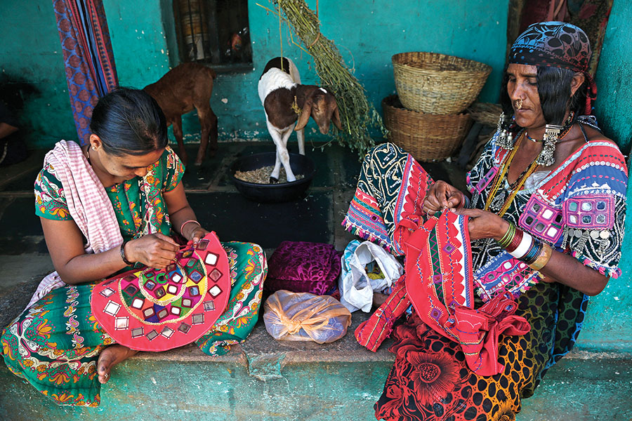 Members of the once-nomadic Lambani tribe embroider indigenous designs on artefacts for sale