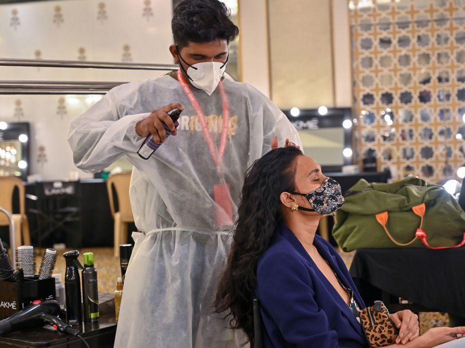 5_Hair stylists prepare a model backstage with safety precautions at the shoot for Lakmé Fashion Week 2020