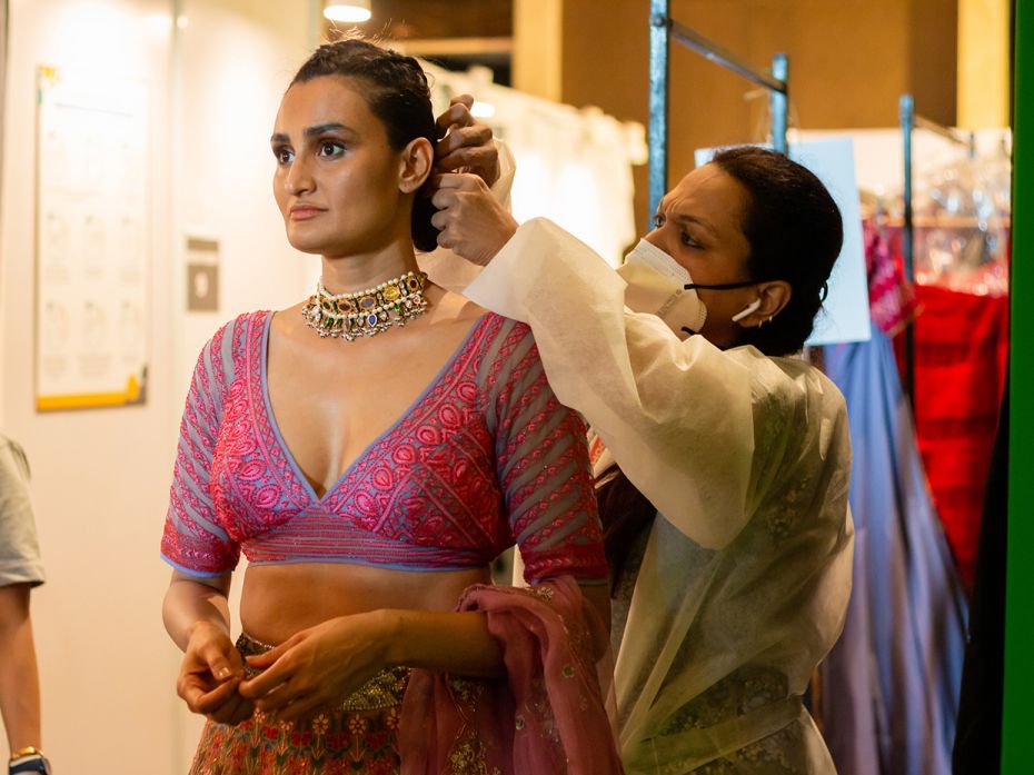 7_Finishing touches for model before a shoot at Lakmé Fashion Week 2020